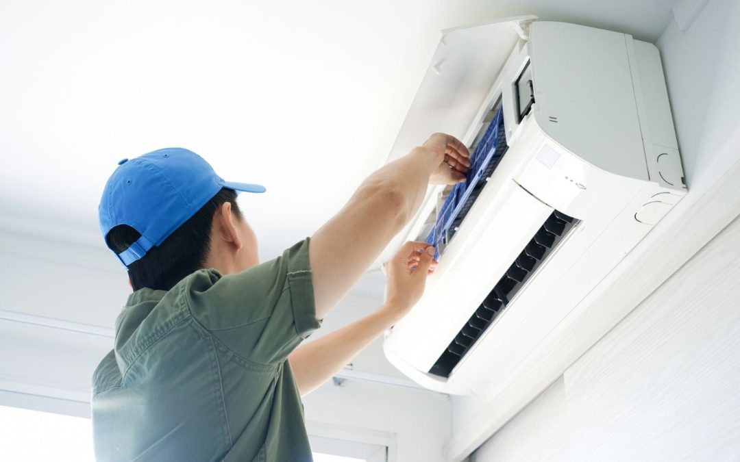 Air conditioning technician maintaining an indoor mini split system in Kingman, AZ